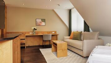 Deluxe Suite | Living area | 45-inch flat-screen TV with cable channels