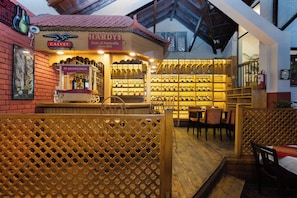 An indoor bar area with wooden furniture and a wine display. - Aawas Boutique Hotel - Central Thamel (Kathmandu)