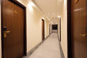 A hotel corridor with wooden doors, a tiled floor, and a sign indicating room number 109. - Aawas Boutique Hotel - Central Thamel (Kathmandu)