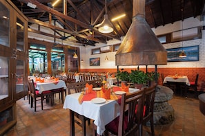 A restaurant with brick walls, wooden beams, and tables set for dining. - Aawas Boutique Hotel - Central Thamel (Kathmandu)