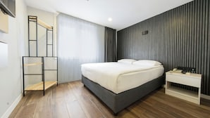 A modern bedroom with a bed, bedside table, and a built-in shelf. - Legend Tulip Hotel (Antalya)