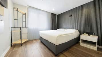 A modern bedroom with a bed, bedside table, and a built-in shelf.