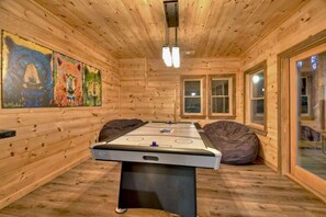 A wooden room with a foosball table, bean bag chairs, and artwork on the walls. - Altitude Blue Ridge - Awesome Views & 4 King Beds (Blue Ridge)