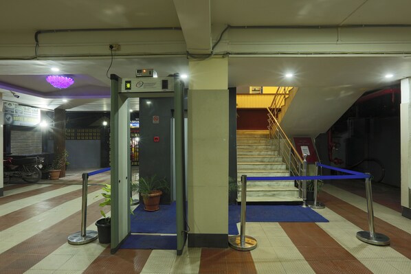 A hotel lobby with a reception desk, a staircase, and a blue carpet. - HOTEL BLUE BIRD (Nagaon)