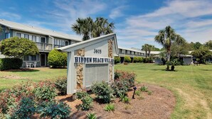 A sign for 'Hidden Beach Villas' with a number '3605' and a well-maintained lawn with various plants and a small tree. - 2 Minutes to the Beach, Condo in Seagrove Beach + Free Attraction Tickets! (Santa Rosa Beach)