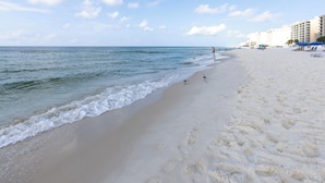 A beach with a clear sky, calm sea, and footprints in the sand. - Westwind 204- 5 Star View! Gulf Front! Location X3! Desired Home! (Gulf Shores)
