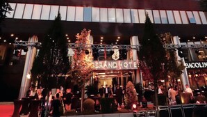 A modern hotel with a prominent "DERAND HOTEL" sign, featuring a multi-story structure with large windows and a well-lit entrance. - Derand Hotel (Pristina)