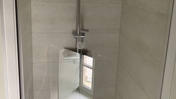 Shower, hair dryer, towels, toilet paper