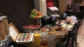 A breakfast buffet with various food items and beverages.