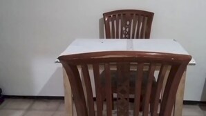 A dining table with two wooden chairs. - OYO Life  92842 Homestay Balearjosari (Malang)
