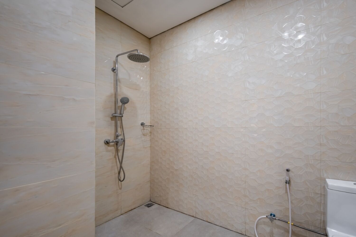 A bathroom with a shower, toilet, and sink.