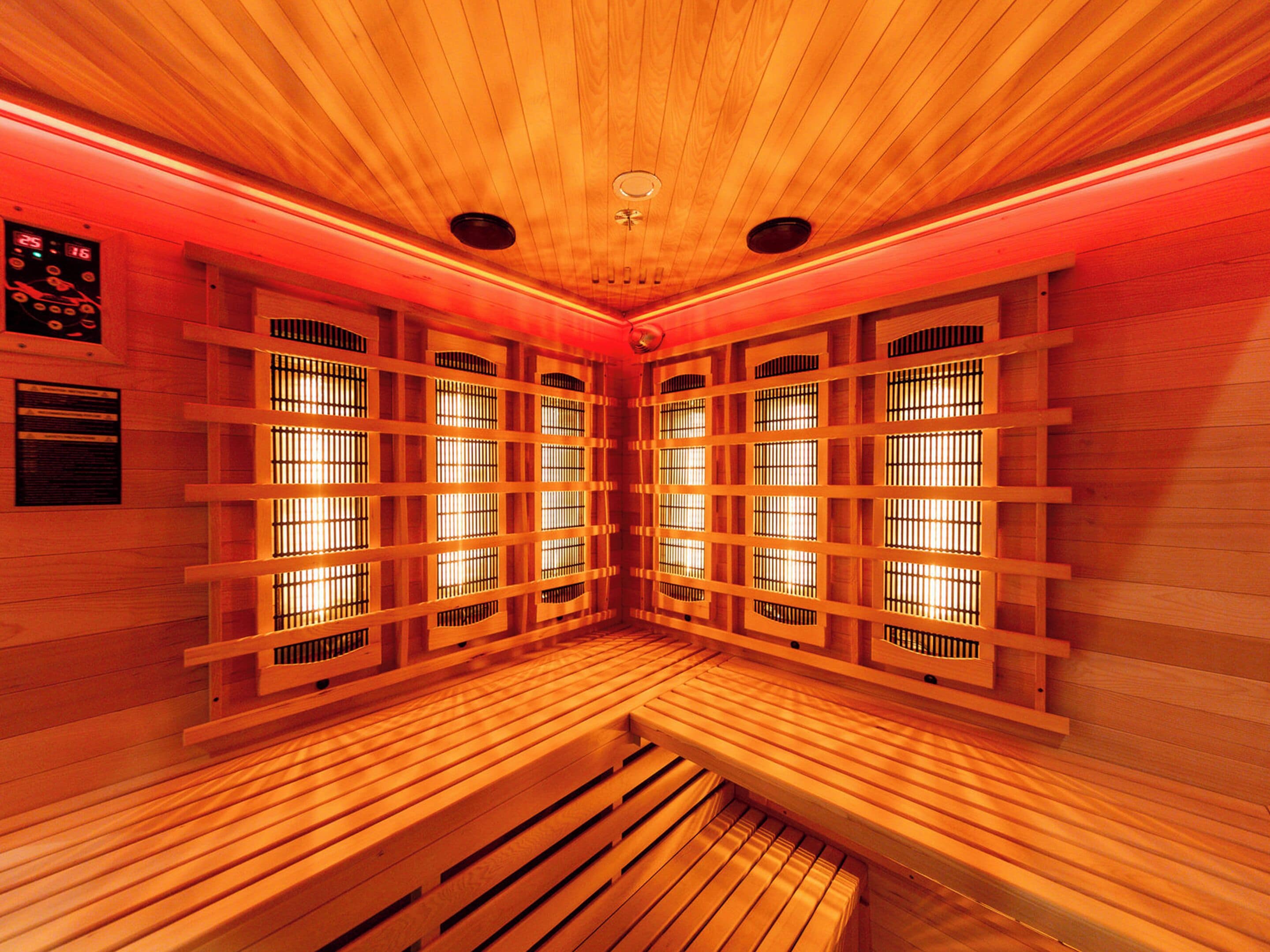 A sauna room with wooden benches and slatted walls.