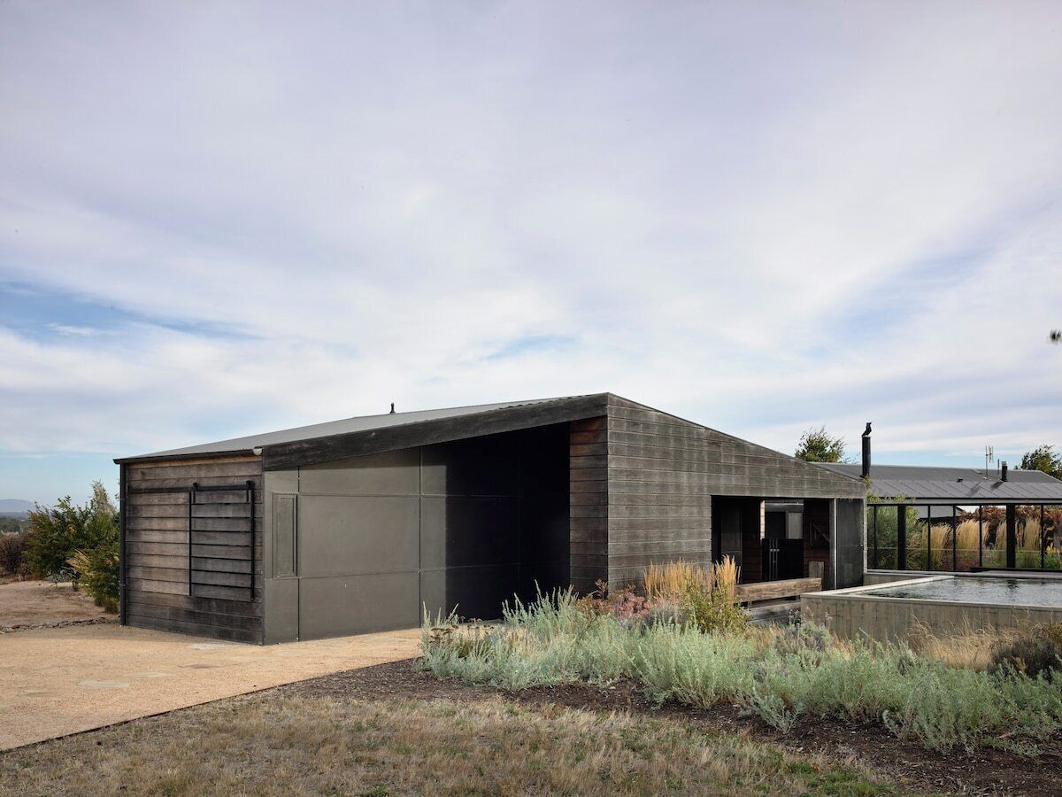 A modern building with a garage and a covered outdoor area.