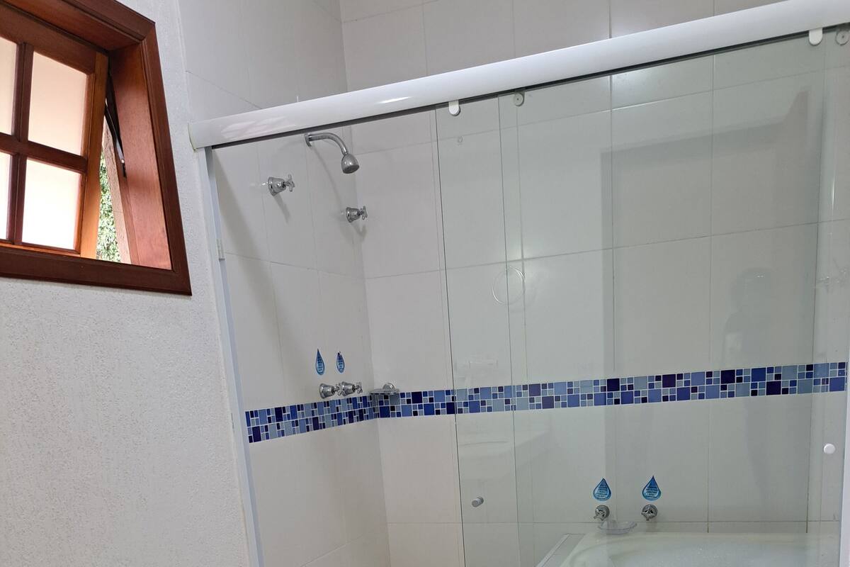 A bathroom with a toilet, bidet, and a glass-enclosed shower area.