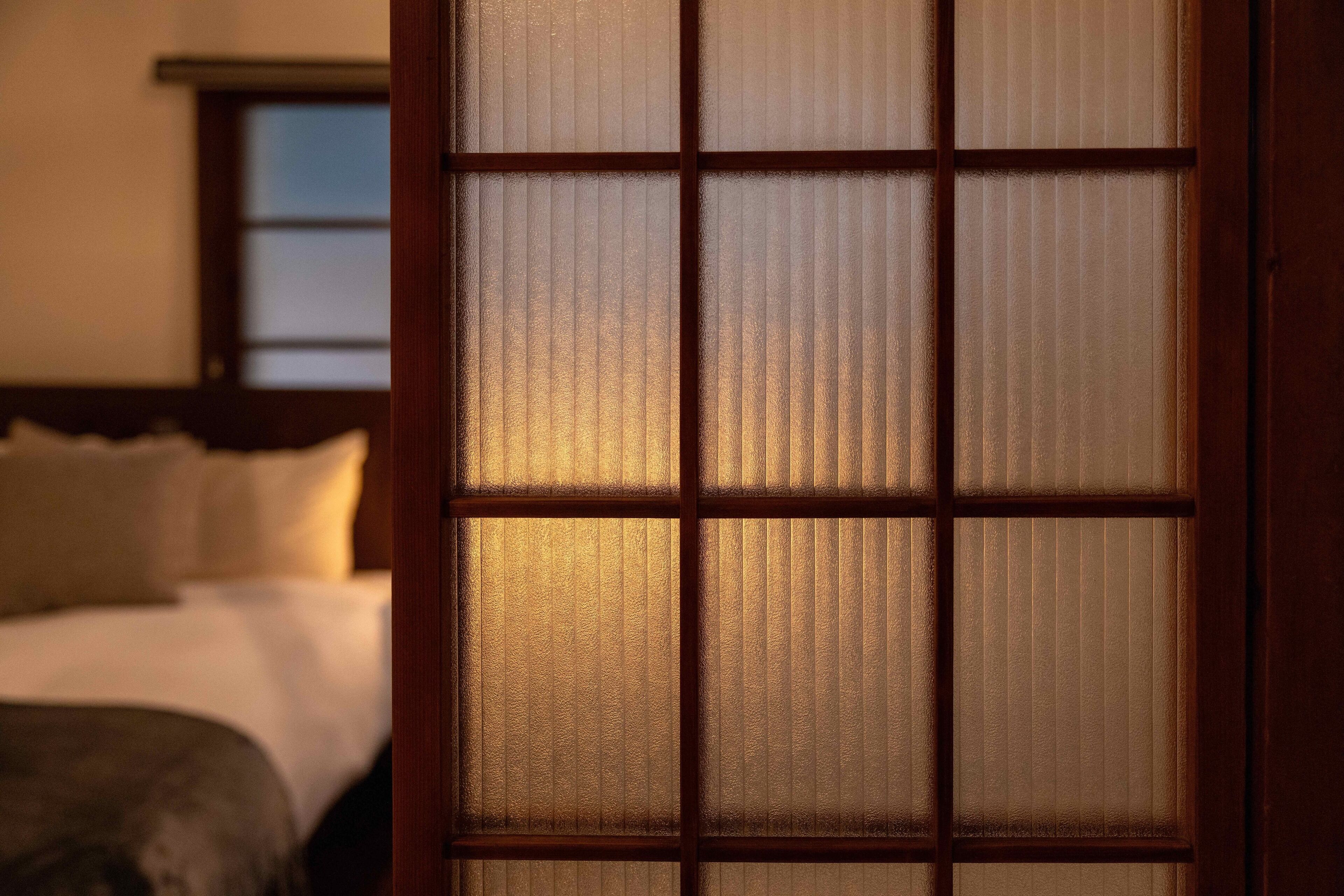A room with a bed and a window with a view.