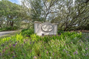 Welcome to the Amelia Surf and Racquet Club, surrounded by lush greenery and beautiful flowering plants.