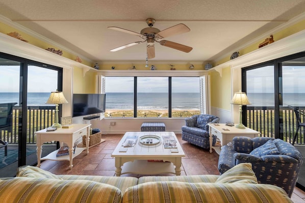 Relax in this ocean-view living area with a bay window, flat-screen TV, and comfortable seating.