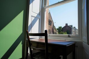 A room with a window, a chair, and a table. - Fantastic 2 Bedroom, Spacious and Great Location! (Helensburgh)