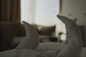 A bed with white pillows and a neatly made bedspread.