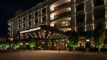 A multi-story hotel with a prominent entrance and a sign reading "The Global Ambassador."