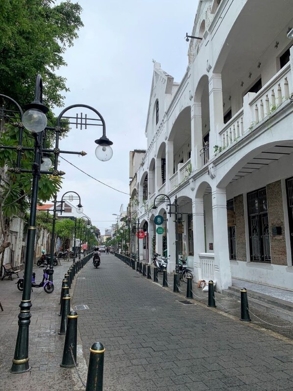 A street lined with white buildings, black bollards, and street lamps. - The Raden Patah Heritage Kota Lama (Semarang)
