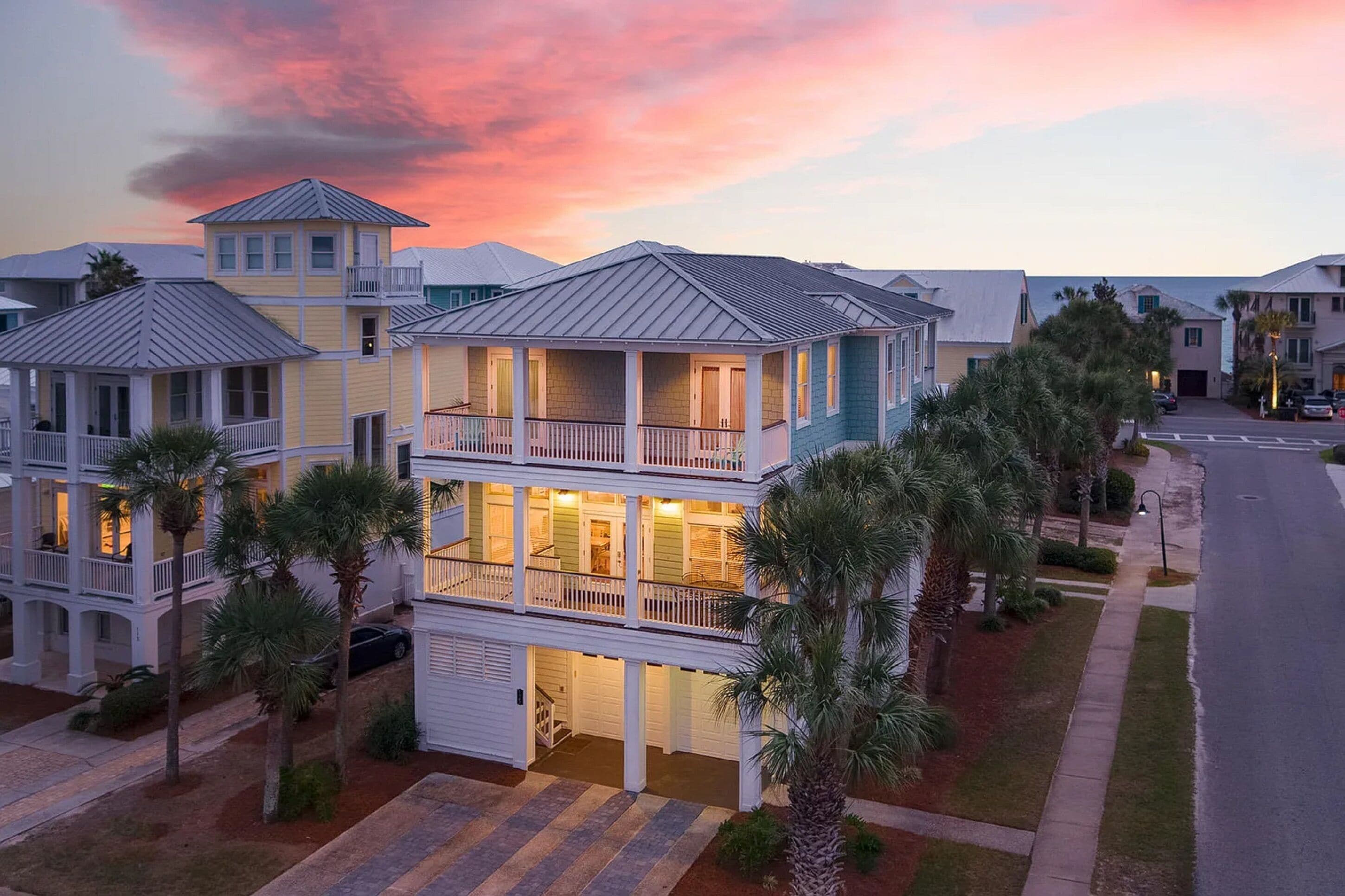 A multi-story residential building with balconies, a garage, and a driveway.