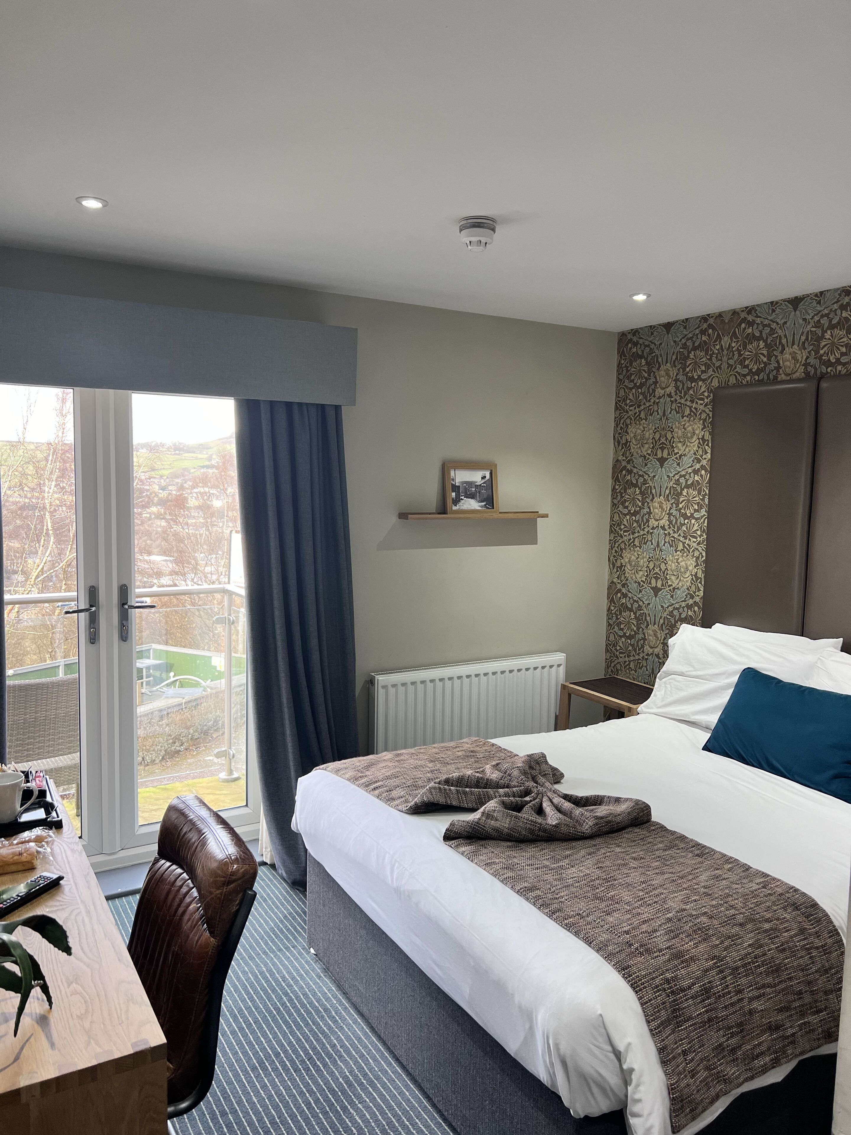 Desk, laptop workspace, iron/ironing board, bed sheets