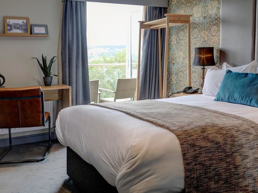 Desk, laptop workspace, iron/ironing board, bed sheets