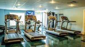 A gym with multiple treadmills and elliptical machines. - Branson | Cozy Waterfront Retreat | Pool + Lake (Branson)