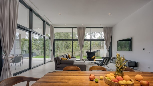 A spacious living room with a large wooden table, a sofa, and a TV. - House K2 (Kanfanar)