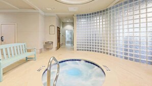A spa area with a pool, a bench, and a glass partition. - Family favorite! On the beach! Amazing amenities! (Orange Beach)