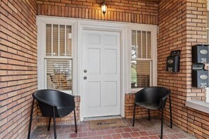 Welcome to your home away from home, where a cozy entrance awaits with a comfortable seating area and convenient mailbox.