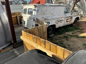 Relax in a serene rural setting, surrounded by a wooden fence and a vintage van.