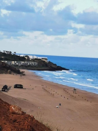 On the beach, sun-loungers, beach towels. Appartement Avec Piscines, vue sur mer et Accès à la Plage