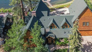 Un chalet doté de plusieurs cabanes, d’un quai et offrant une vue sur le lac.