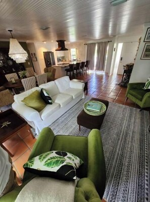 Relax in this stylish living space with a large sofa, armchair, and coffee table.