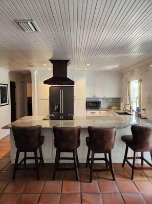 Enjoy cooking in this well-equipped kitchen with a central island and ample natural light.