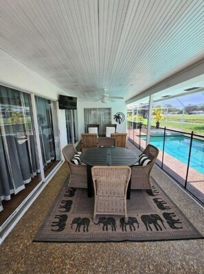 Enjoy dining al fresco in this outdoor space with a round table and comfortable seating.