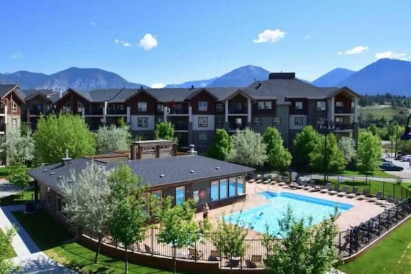 Relax by the pool surrounded by lush greenery and breathtaking mountain views.