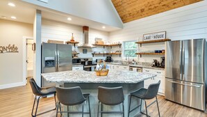 A modern kitchen with a central island, stainless steel appliances, and a sign reading "LAKE HOUSE". - Luxe Kentucky Cabin Rental ~ 36 Mi to Mammoth Cave (Cub Run)