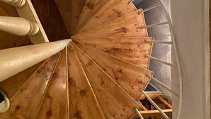 A wooden spiral staircase with white railings and a handrail. - 35 Arsena St (Tbilisi)