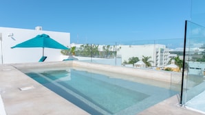 A rooftop infinity pool with a clear view of the city skyline. - Brand New Penthouse at Anah with 2 bedrooms and private roof top terrace! (Solidaridad)