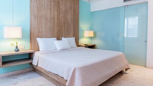 A bedroom with a bed, bedside tables, a nightstand, a vase with flowers, and a wardrobe. - Brand New Penthouse at Anah with 2 bedrooms and private roof top terrace! (Solidaridad)