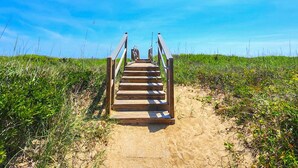 A wooden staircase leading up a sandy path surrounded by green vegetation. - ENDLESS SUMMER 2 is the ideal location with Private Pool (Southern Shores)