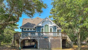 A two-story house with a covered porch and a garage.