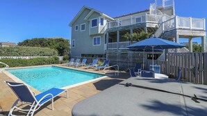 A pool area with lounge chairs, a covered seating area, and a multi-level deck with railings. - Sea & Ease - Enjoy superb ocean views and great beach access from this home w/Private Pool! (Southern Shores)