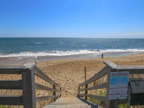 A wooden staircase leading to a sandy beach with a clear view of the ocean. - FIREQUACKER - Pet Friendly 4 BR Oceanside Home w/Private Pool (Duck)