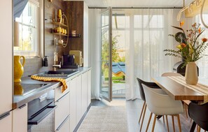 Fridge, stovetop, dishwasher, coffee/tea maker