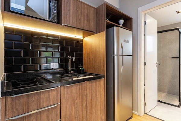 Full-size fridge, microwave, stovetop, cookware/dishes/utensils
