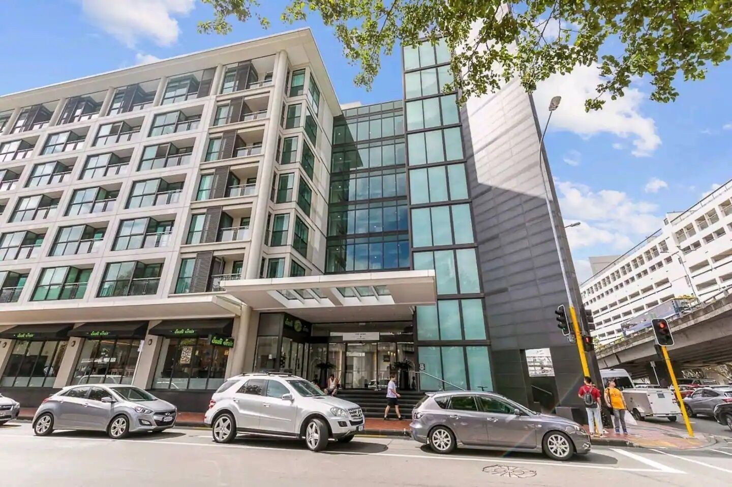 A modern building with multiple floors, large windows, and a prominent entrance.